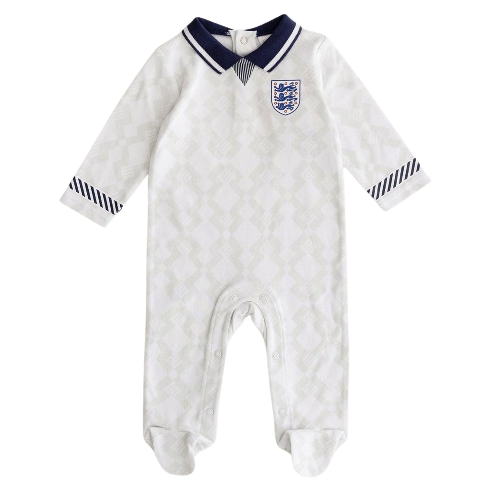 A white England Football 1990 retro baby sleepsuit with a geometric pattern, featuring the England Football national team badge on the chest and navy blue collar and cuff details.